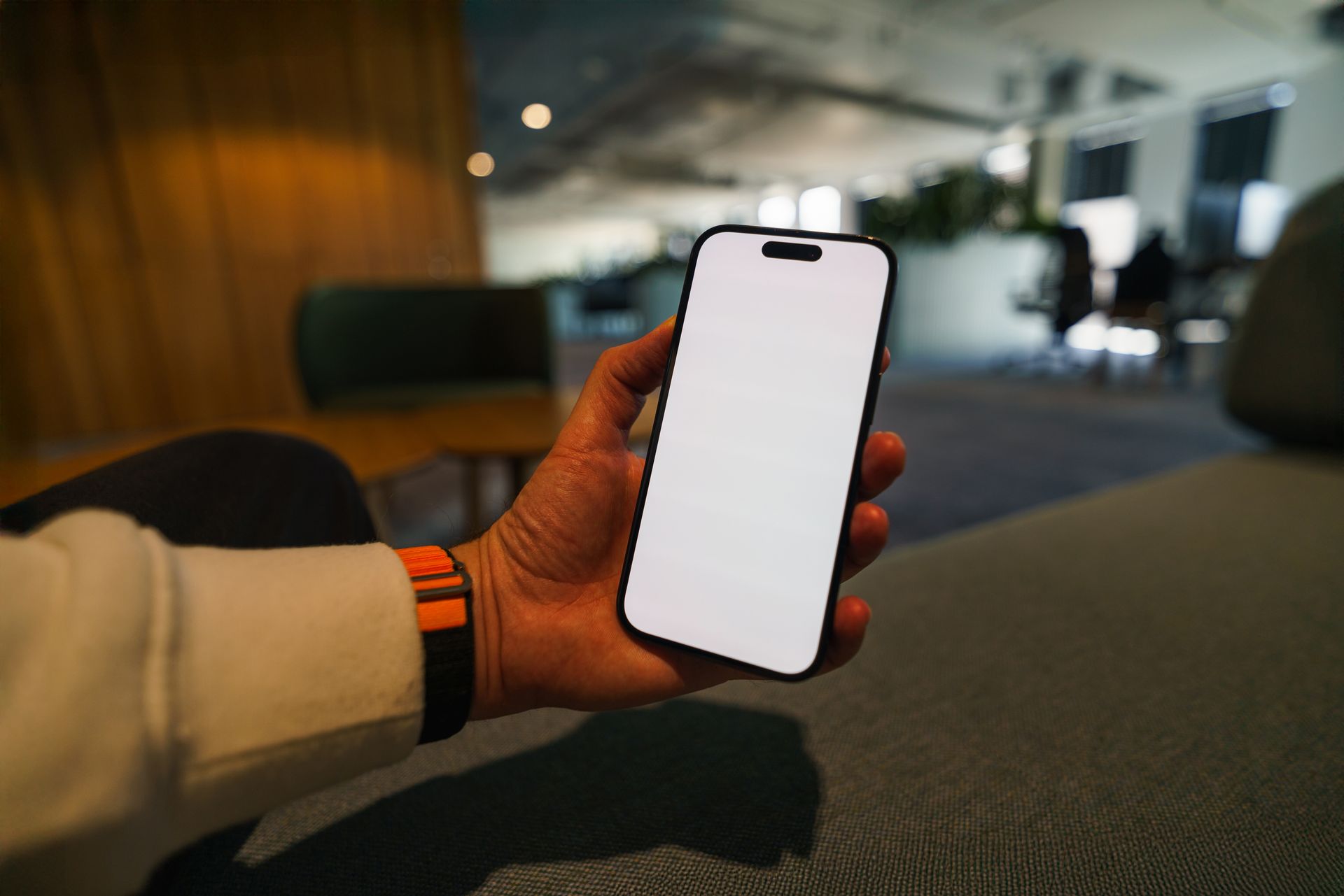 Laptop and phone with blank mockup screens on a sunlit desk