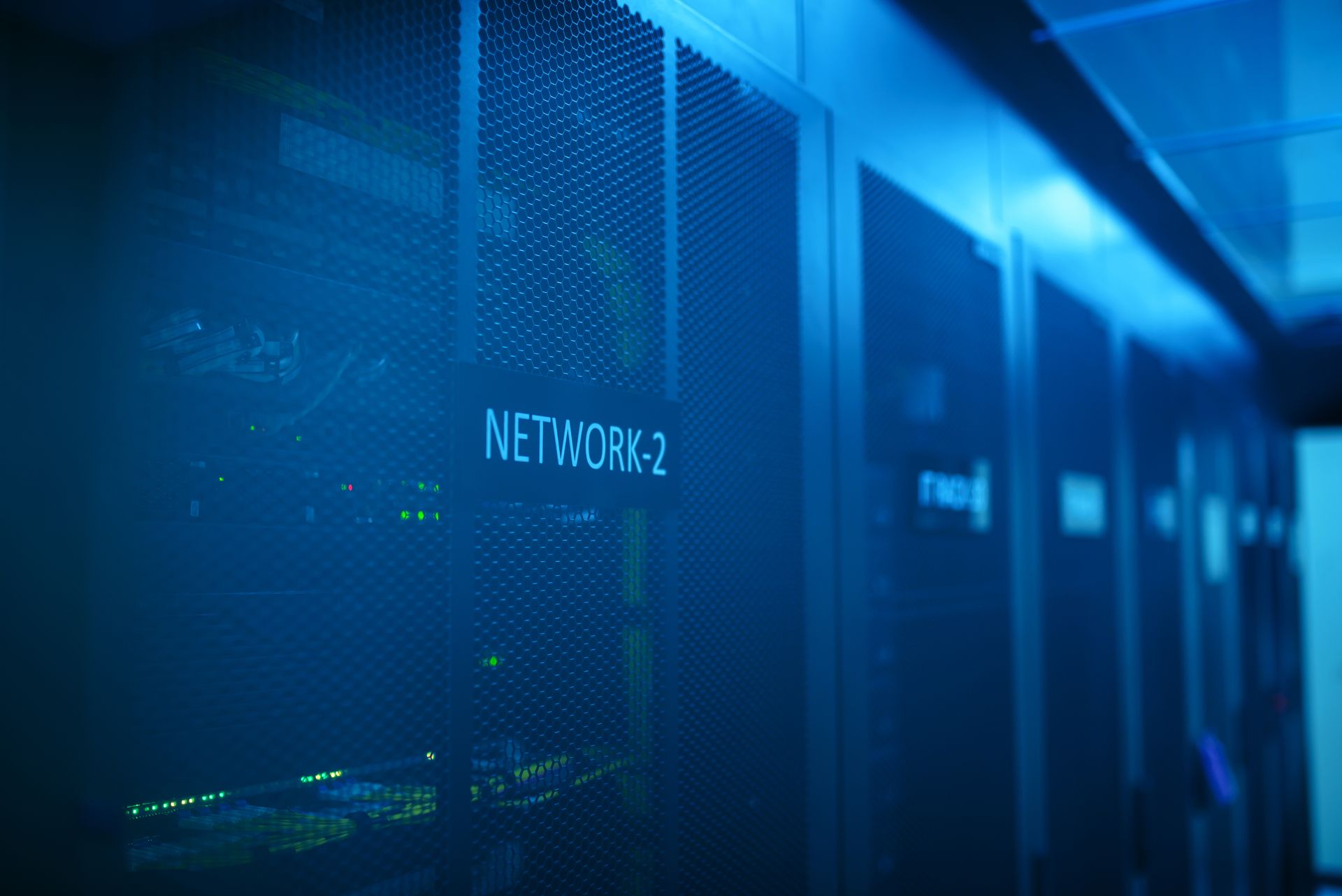 Real photo of a modern data center server rack with blue lighting