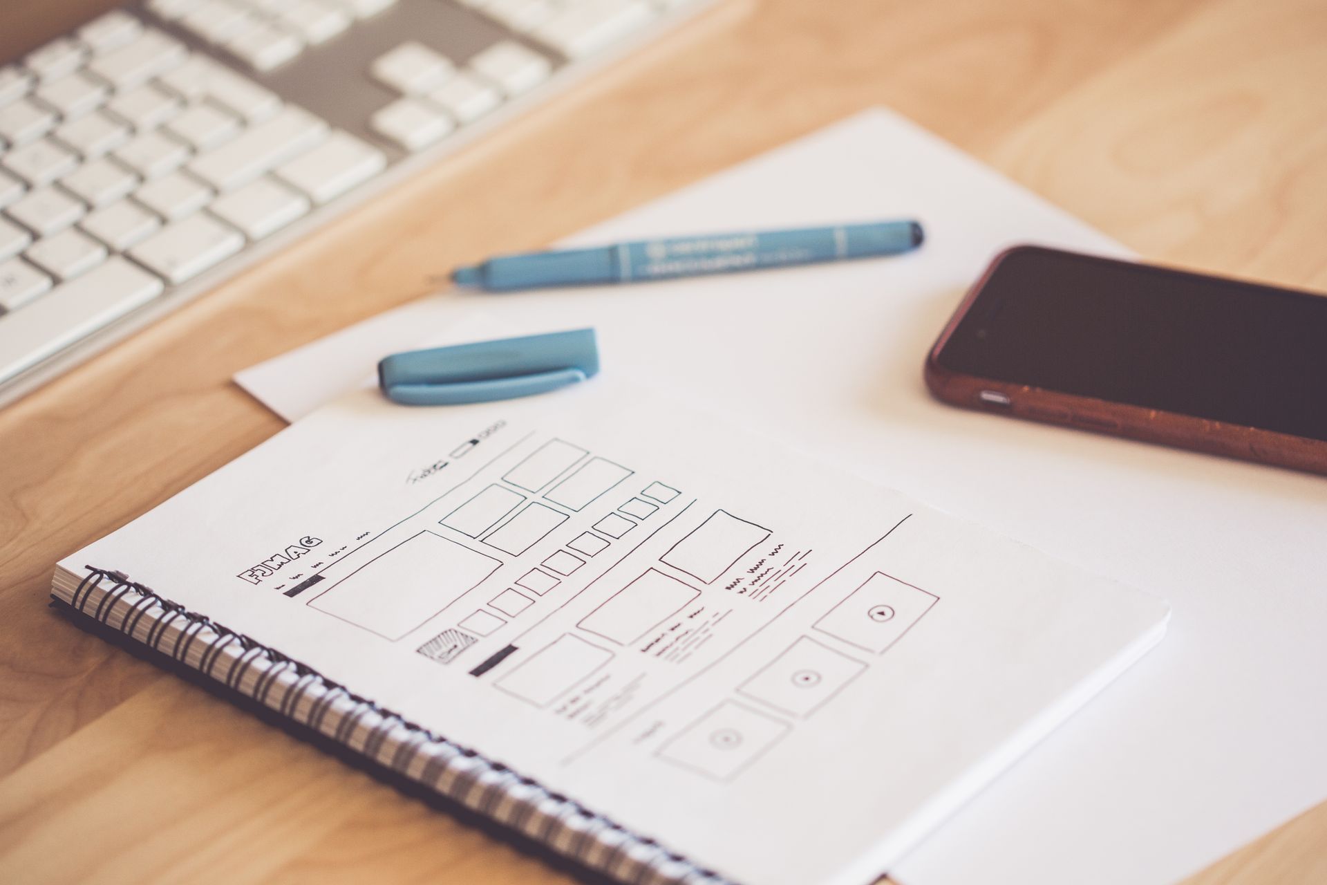 Hand-drawn UX wireframe sketches in a notebook